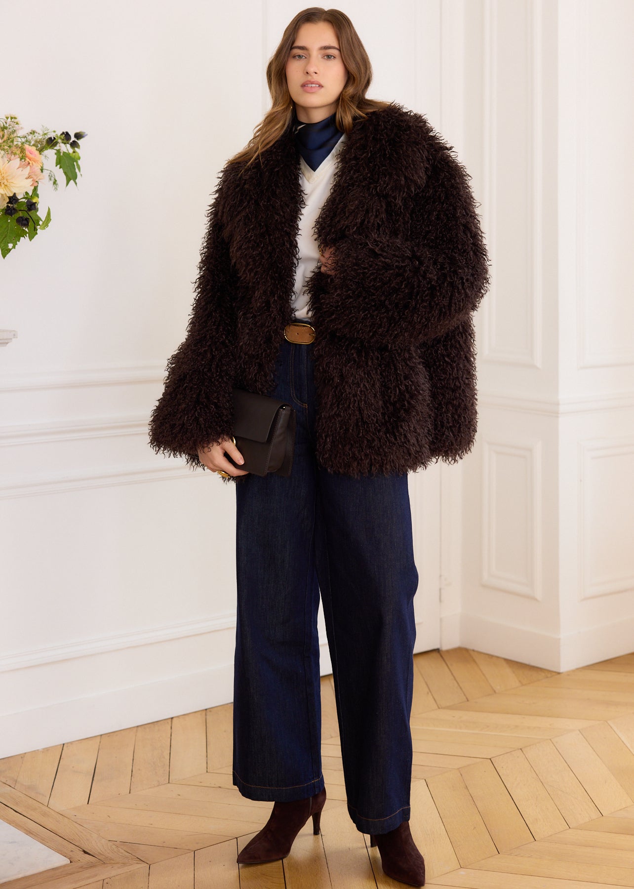 Brown faux fur coat with curly hair, long sleeves, and a round